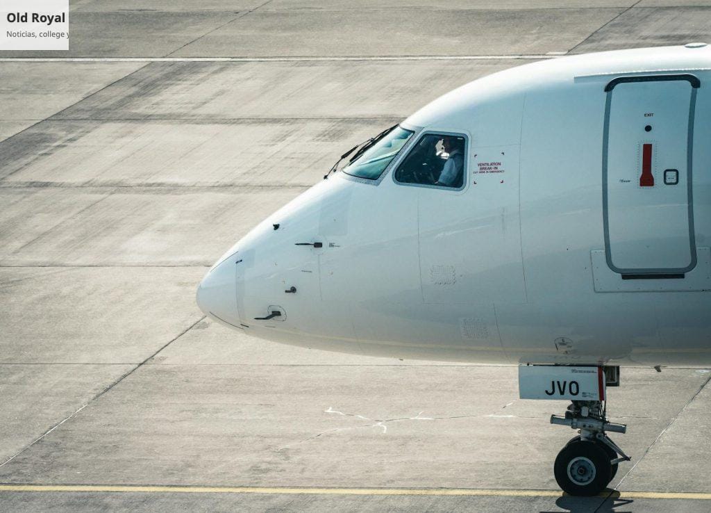 A white airplane sitting on the tarmac with its nose pointed down